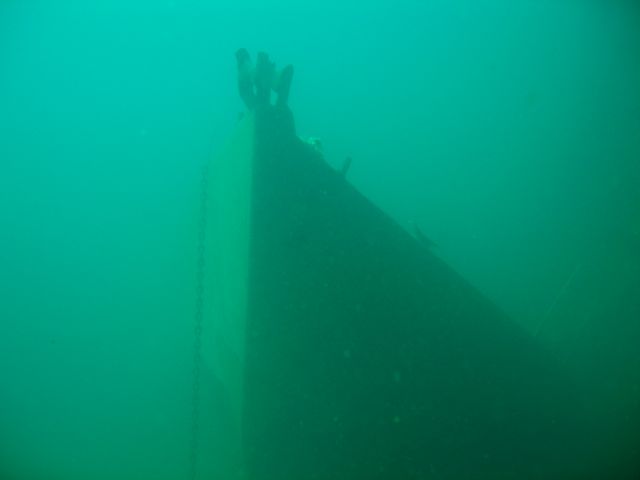 Bow of Sailboat Next to USS Indra