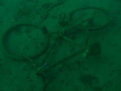 Bicycle in Sand Next to USS Indra
